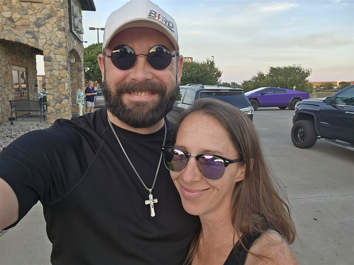 Mike Ahern and his wife smiling together outdoors